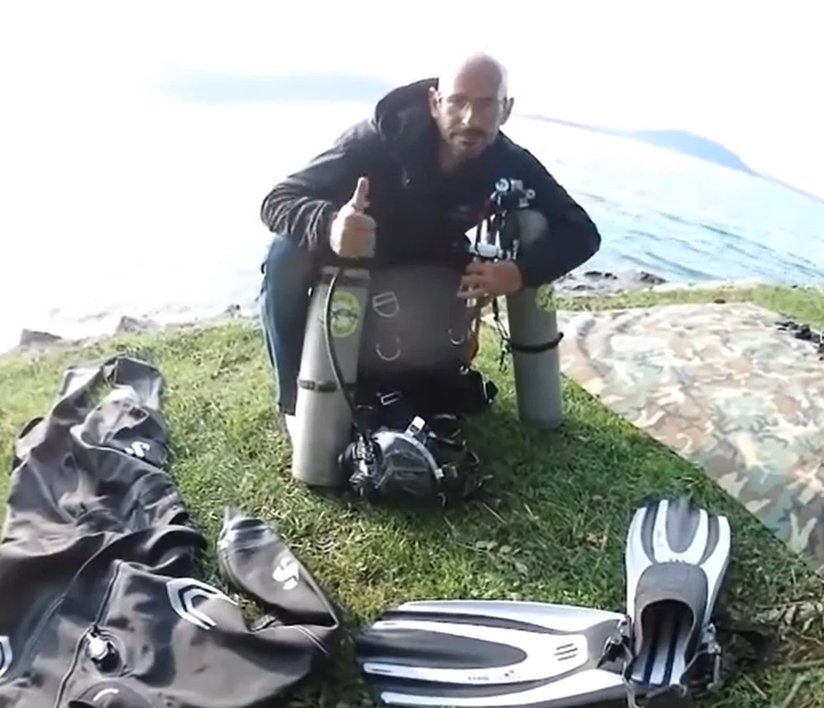 Chris K. with dive gear on shore