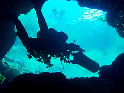 Cave diver with underwater propulsion vehicle